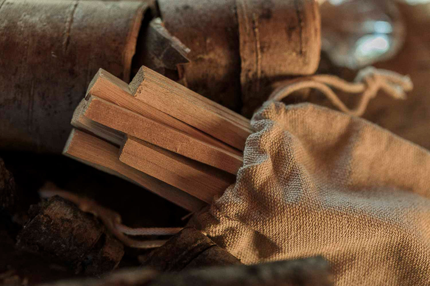 Close-up of wooden blocks and a cloth bag with a rustic background