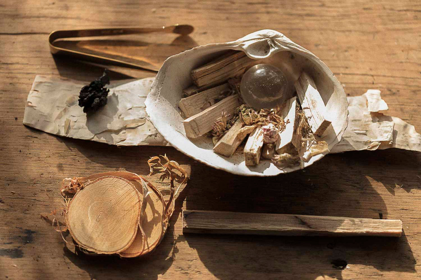 Herbal items in a shell on a wooden surface