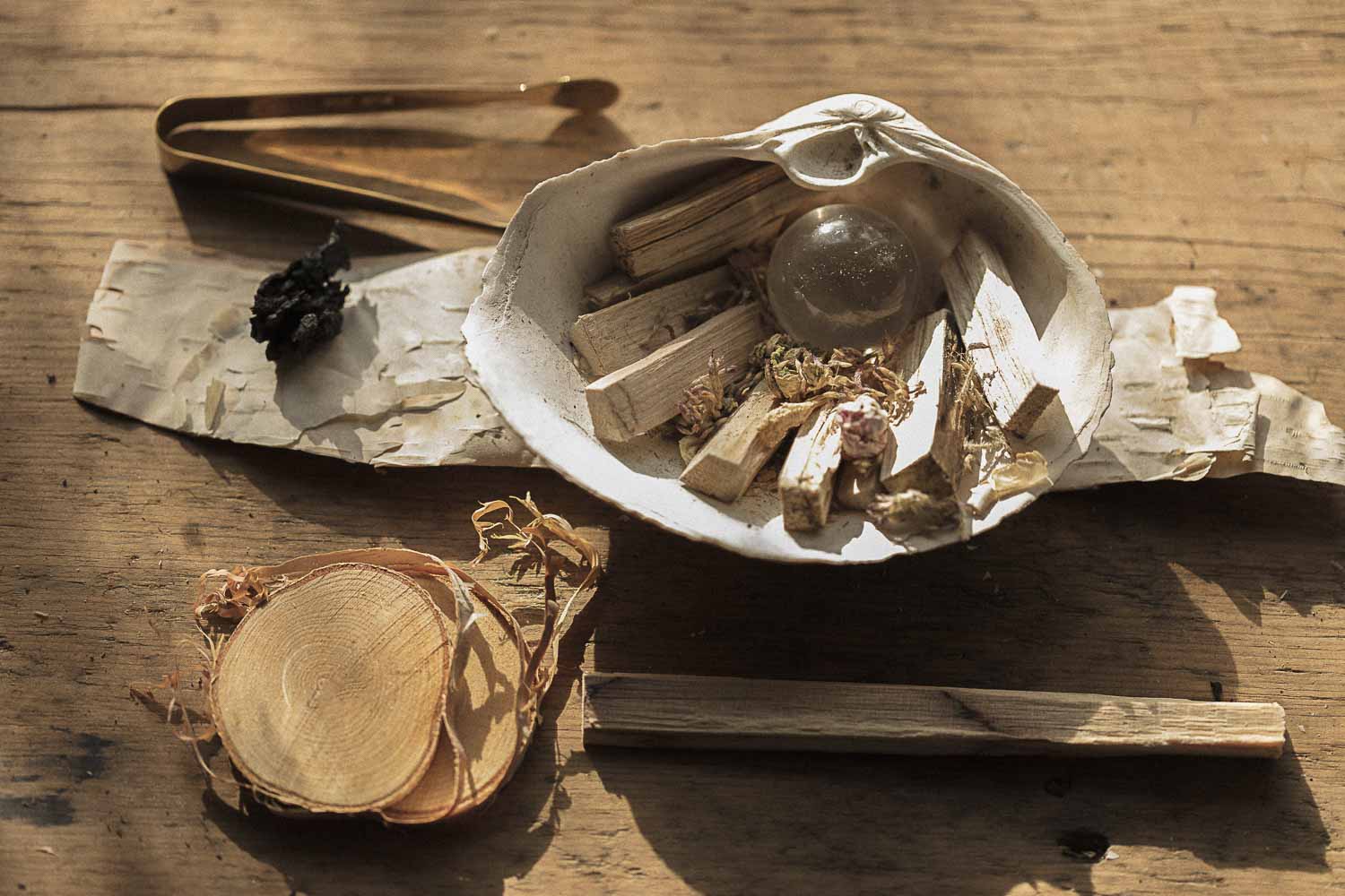 Herbal items in a shell on a wooden surface