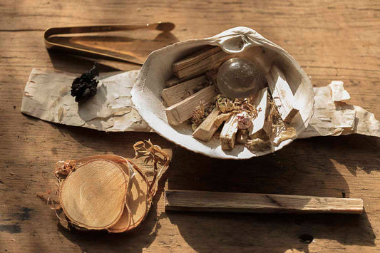 Herbal items in a shell on a wooden surface
