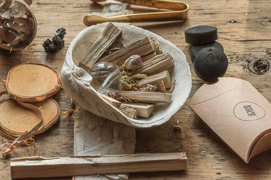 Birch elements in a bowl on a wooden surface with a box labeled 'WYLDE GOLD'.