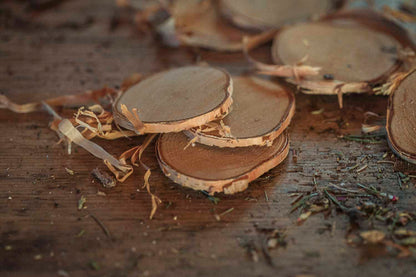 Stack of birch slices on a wooden surface with dried herbs