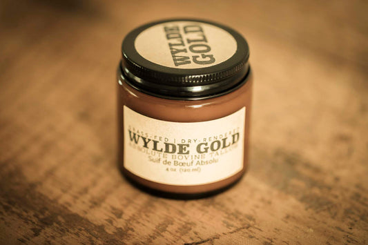 WYLDE GOLD Absolute Balm — unscented grass-fed tallow ritual in a jar on wood