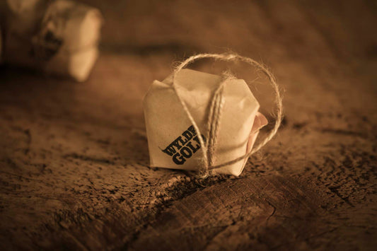 WYLDE GOLD Savage Balm —  grass-fed tallow muscle relief hot/cold balm block wrapped  in kraft on rustic wood