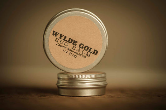 WYLDE GOLD Bug Balm —  grass-fed tallow bug repellent balm in a tin on rustic wood