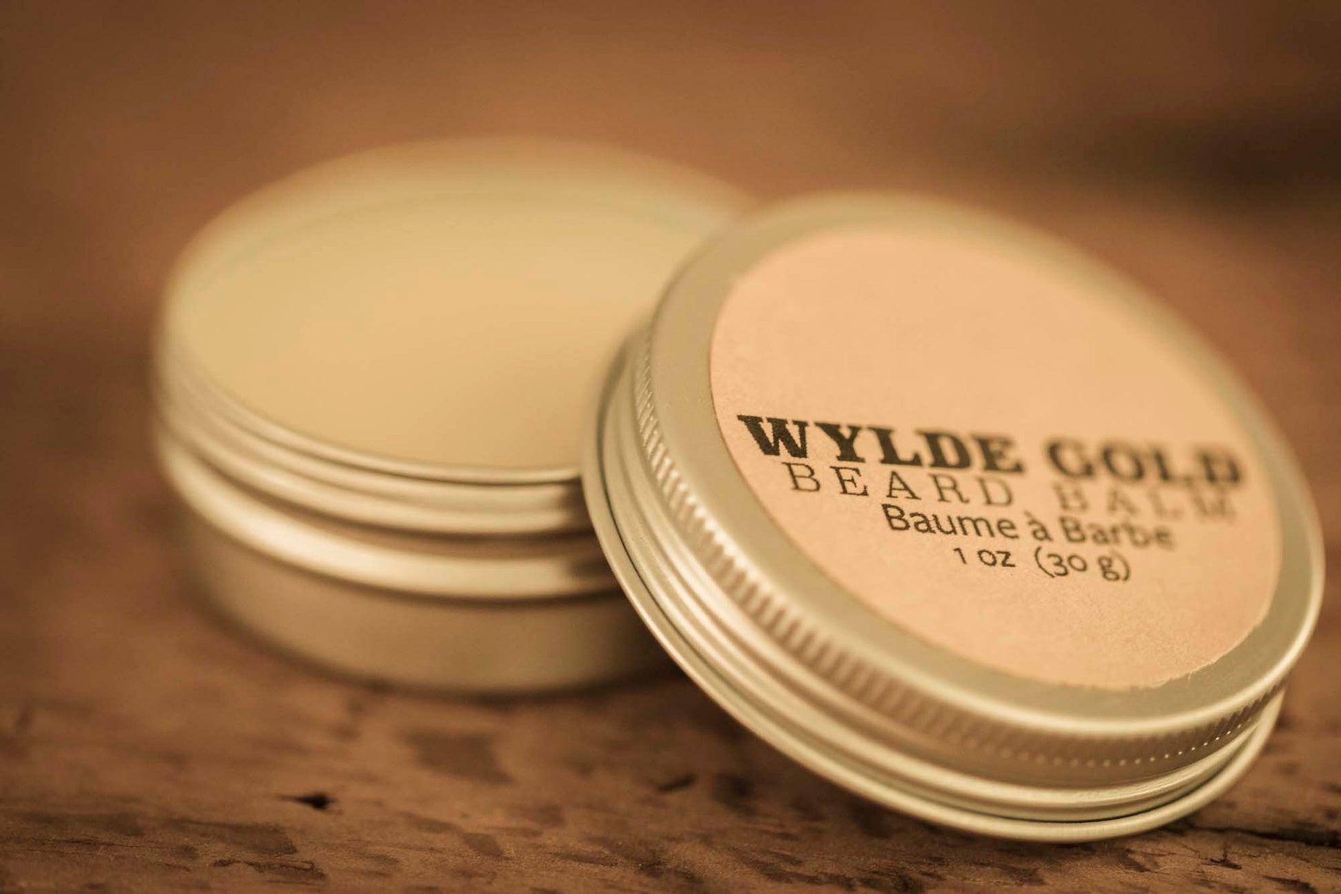 WYLDE GOLD Beard Balm —  grass-fed tallow balm in a tin on rustic wood