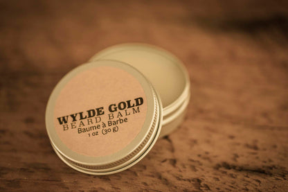 WYLDE GOLD Beard Balm —  grass-fed tallow balm in an open tin on rustic wood
