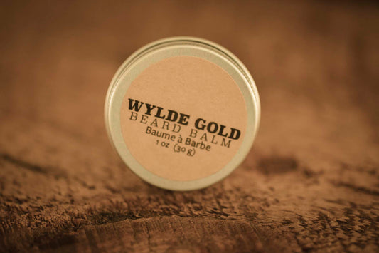 WYLDE GOLD Beard Balm —  grass-fed tallow balm in a tin on rustic wood