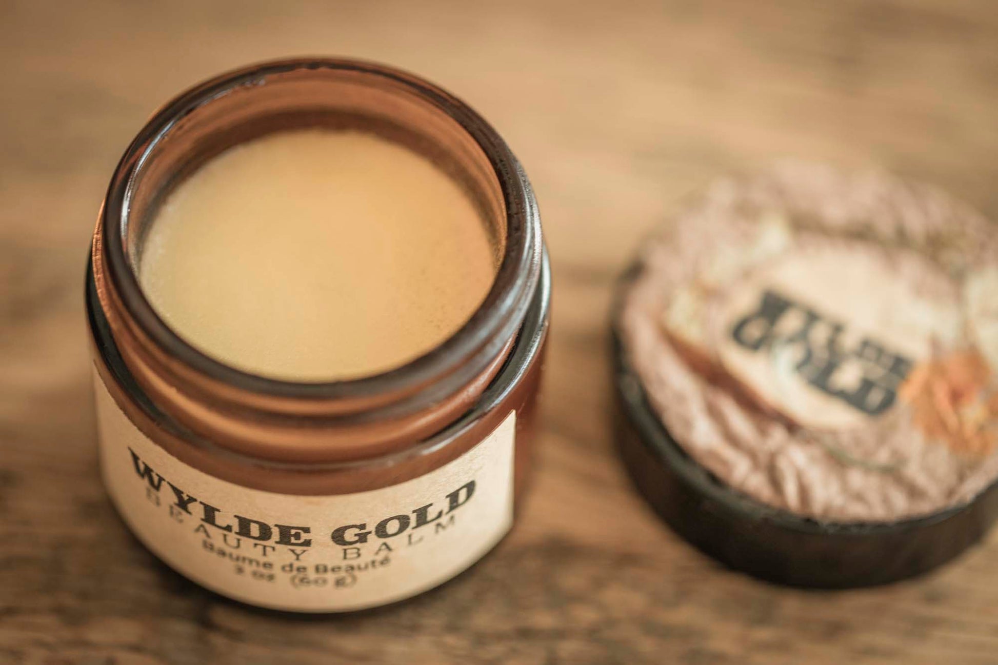An open jar of molten-gold balm, smooth as moonlit butter, waiting to melt into skin.